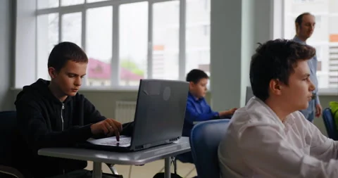 Smart Boys Students In Classroom, Pupils Working With Laptops Ad Teacher Walking Stock Footage 280174704