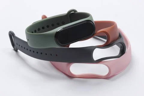 Smart bracelet with interchangeable straps on a white background. Modern gadg Фото