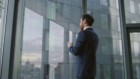 Smart businessman calling partners using smartphone in modern office close up. Stockfoto's