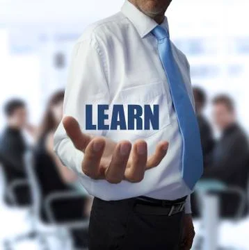 Smart businessman holding the word learn Stock Photos