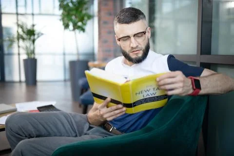 Smart businessman improving his knowledge about taxes 写真素材