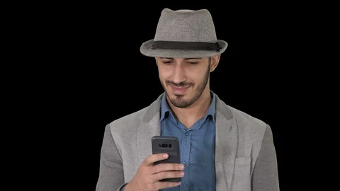 Smart casual arabian man using smartphone while walking, Alpha Channel Stock Footage 115998980