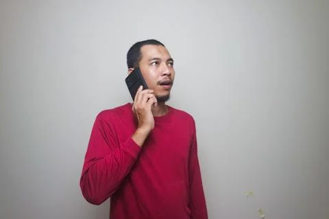 Smart casual asian man using smartphone in studio background Stock Photos