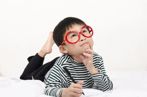 Smart child lying on bed Stock Photos