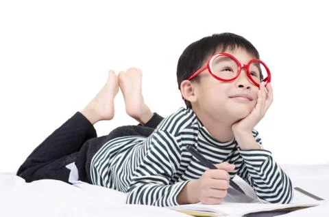 Smart child lying on bed Stock Photos