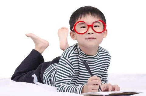 Smart child lying on bed Stock Photos