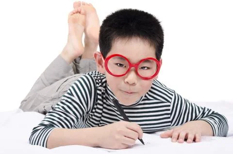 Smart child lying on bed Stock Photos
