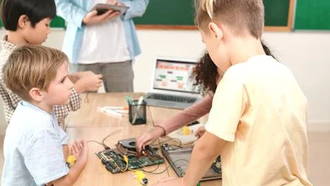 Smart children working on electronic board while teacher using tablet. Pedagogy. 写真素材