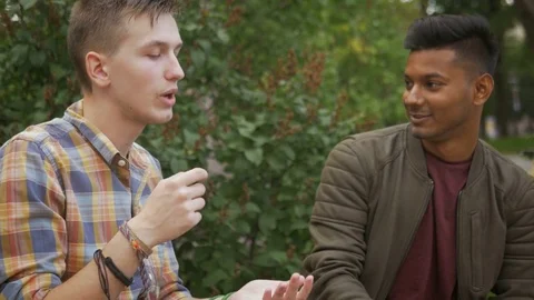 Smart college students discussing a topic outdoors Stock Footage 74564503