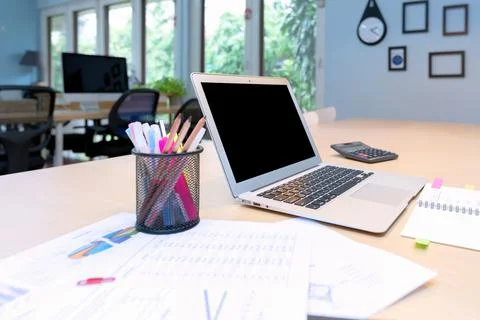 Smart computer and document put on wooden table in Co Working Space Stock Photos