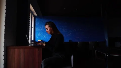 Smart computer programmer with computer does job and writes program sitting in Stock Footage 78505211