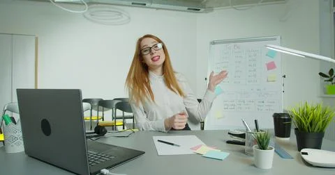 Smart conducts language classes online. Intelligence famale teacher points on Stock Photos