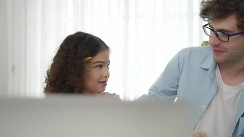 Smart daughter put pencil on ear while dad explain about generated AI. Pedagogy. Stock Footage 268744837