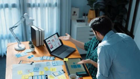 Smart developer compare Ux Ui design and planning for development. Convocation. Stock Photos