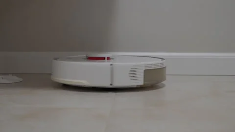 Smart Device Cleans Cheerfully: Robot Vacuum Whirs Across Floor, Getting to Work Stock Footage 320848105