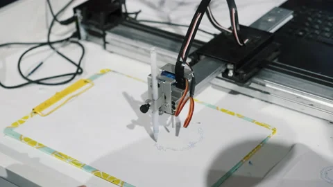 Smart device robot drawing picture, computer execute program, holds blue pen Stock Footage 166803406