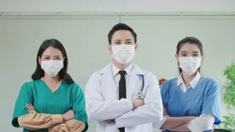 Smart doctor team stood with their arms crossed confidently. Stock Footage 155698203