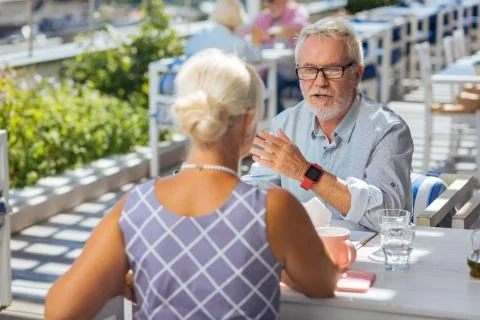 Smart elderly man speaking with his wife Stock Photos