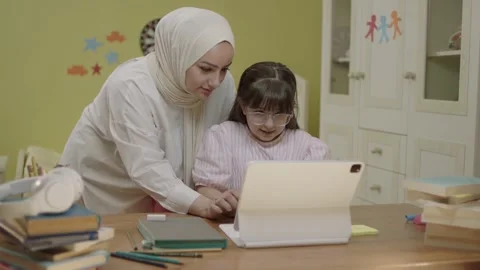 Smart elementary school girl doing math homework with tablet computer Stock Footage 203830534