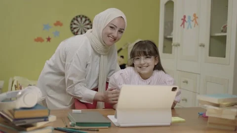 Smart elementary school girl doing math homework with tablet computer Stock Footage 203830549