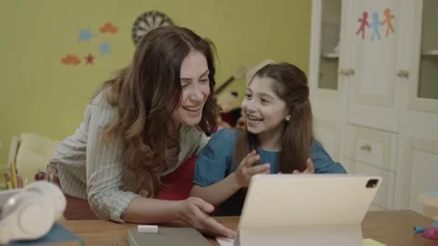 Smart elementary school girl doing math homework with tablet computer Stock Footage 203830832