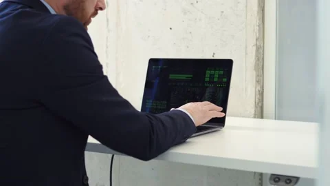 Smart energetic programmer writing code on laptop in a modern coworking center. Video stock 238509615