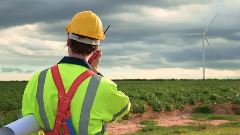 A smart engineer with protective helmet on head, using walkie talkie at ele.. Stock Footage 269099189