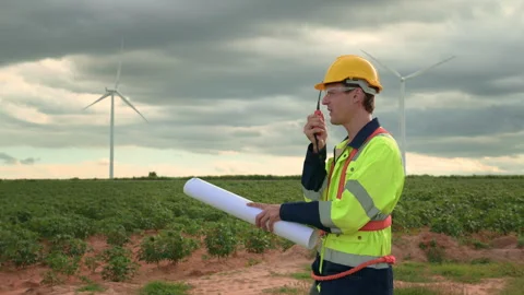 A smart engineer with protective helmet on head, using walkie talkie at ele.. Stock Footage 269099240