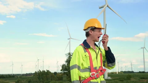 A smart engineer with protective helmet on head, using walkie talkie at ele.. Stock Footage 269099282