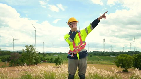 A smart engineer with protective helmet on head, using walkie talkie at ele.. Stock Footage 269099445