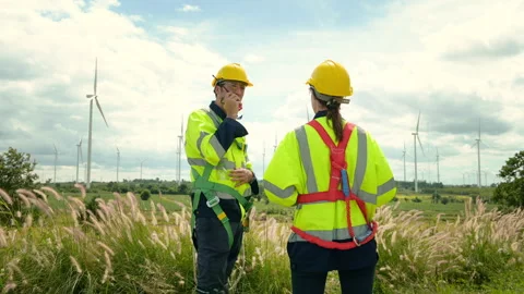 A smart engineer with protective helmet on head, using walkie talkie at ele.. Stock Footage 269099460