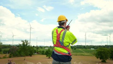 A smart engineer with protective helmet on head, using walkie talkie at ele.. Stock Footage 269099659