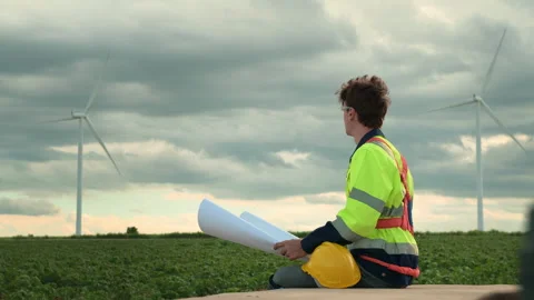 Smart engineer with protective helmet holding the blueprint working at elec.. Stock Footage 269101866