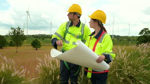 Smart engineer with protective helmet holding the blueprint working Stock Footage 269103112