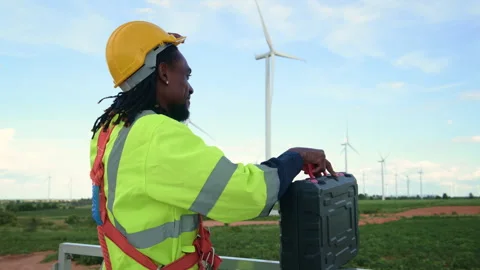 A smart engineer is putting a protective helmet on head at electrical turbi.. Stock Footage 269101091