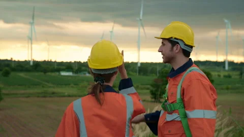 A smart engineer is putting a protective helmet on head at electrical turbi.. Stock Footage 269101095