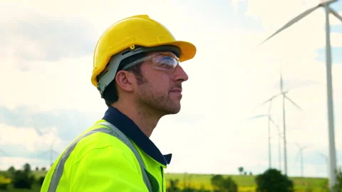 A smart engineer is putting a protective helmet on head at electrical turbi.. Stock Footage 269101202