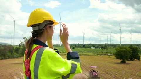 A smart engineer is putting a protective helmet on head at electrical turbi.. Stock Footage 269101336