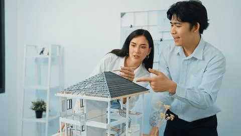 Smart engineer team focusing on checking the house model structure. Immaculate. Stock Photos