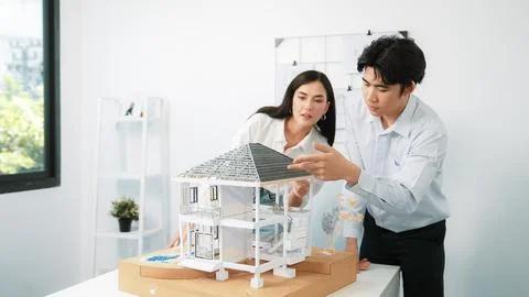 Smart engineer team focusing on checking the house model structure. Immaculate. Stock Photos