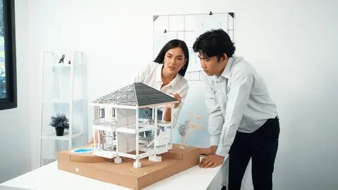 Smart engineer team focusing on checking the house model structure. Immaculate. Stock Photos