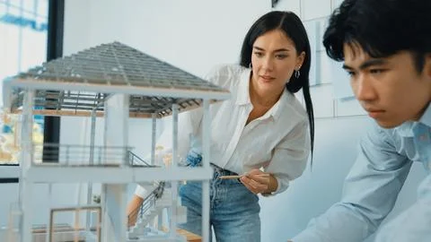 Smart engineer team focusing on checking the house model structure. Immaculate. Stock Photos