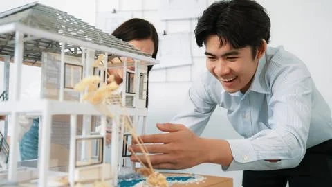 Smart engineer team focusing on checking the house model structure. Immaculate. Stock Photos