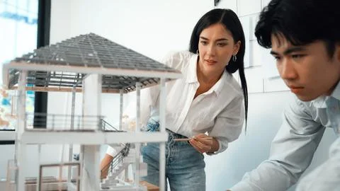 Smart engineer team focusing on checking the house model structure. Immaculate. Stock Photos