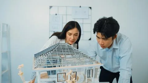 Smart engineer team focusing on checking the house model structure. Immaculate. Stock Photos
