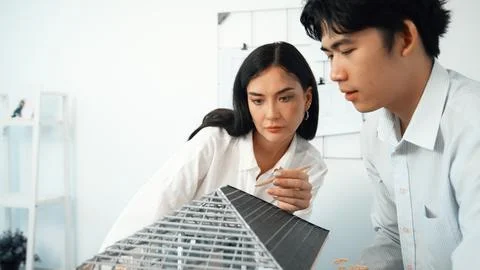 Smart engineer team focusing on checking the house model structure. Immaculate. Stock Photos