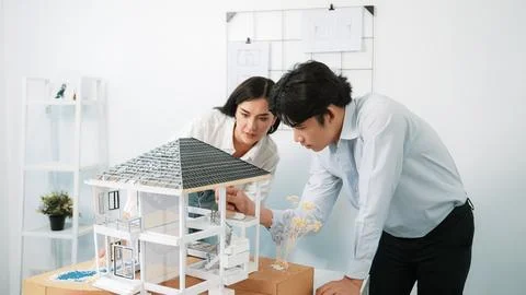 Smart engineer team focusing on checking the house model structure. Immaculate. Stock Photos
