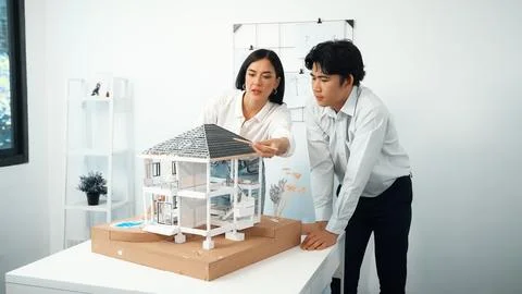 Smart engineer team focusing on checking the house model structure. Immaculate. Stock Photos