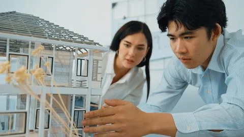 Smart engineer team focusing on checking the house model structure. Immaculate. Stock Photos