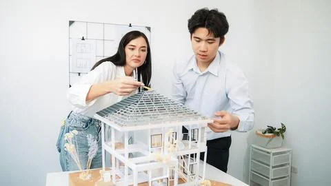 Smart engineer team focusing on checking the house model structure. Immaculate. Stock Photos